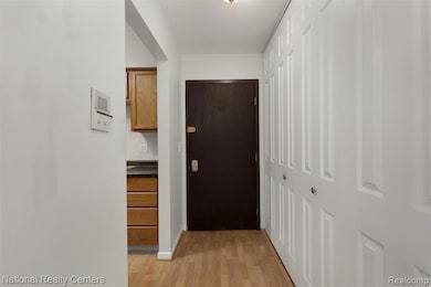 Hall featuring light wood-style flooring and baseboards
