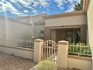 Doorway to property featuring a gate, stucco sidin