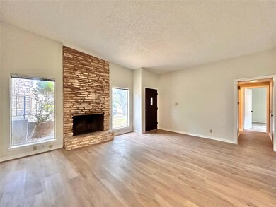 Unfurnished living room featuring a textured ceil