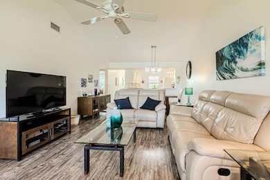 Dining space with dark hardwood / wood-style floors, high vaulted ceiling, and ceiling fan