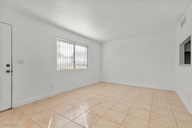 Spare room featuring light tile patterned flooring