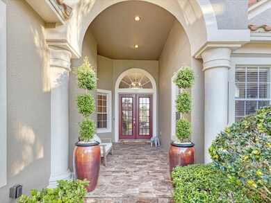 Stately new tiled entry way, vases with manicured 