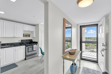 Bright white updated kitchen on the right upon ant