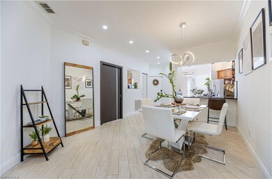 Dining space featuring light wood-style floors, ornamental molding, and recessed lighting