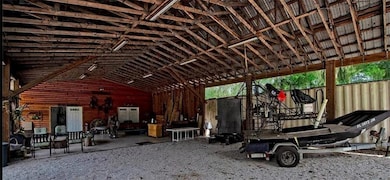 Looking through the polebarn/carport to the entry doors of the main house