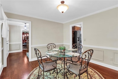 Dining area with wood finished floors, a decorativ