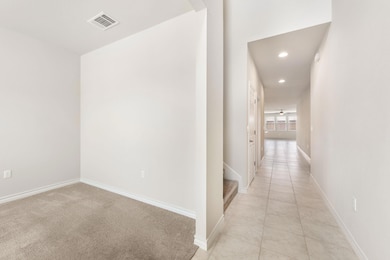 Hall with baseboards, visible vents, and recessed