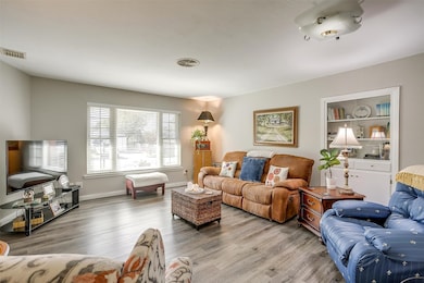 Living area with wood finished floors and baseboards