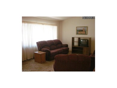 The living room features a neutral layout and a la