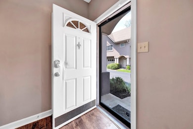 Foyer entrance featuring wood finished floors and baseboards