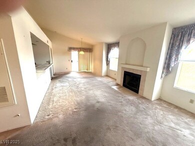 Unfurnished living room with light carpet, vaulted