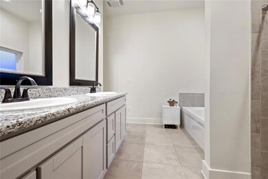 Spacious primary bath with double vanity for toile
