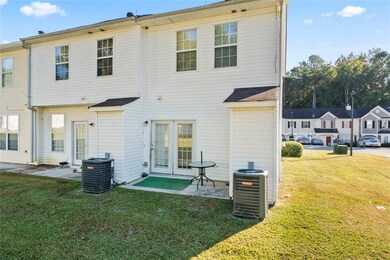 Back of property with central AC and a yard