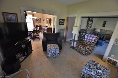 The main floor provides a living room, den, dining
