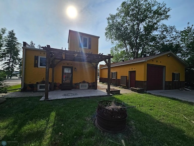 Back view with pergola over the patio