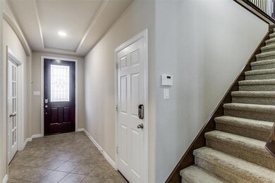 A spacious entryway with garage access, study with