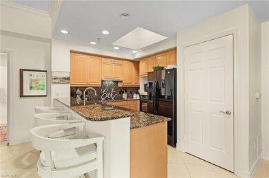 Kitchen featuring dark stone counters, kitchen pen
