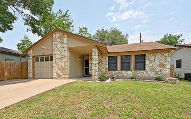 View of front of house with stone siding, an atta