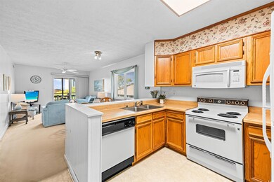 Kitchen with a peninsula, light countertops, white