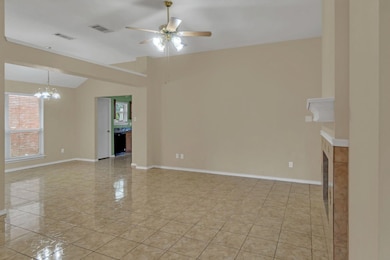 Unfurnished living room featuring ceiling fan with