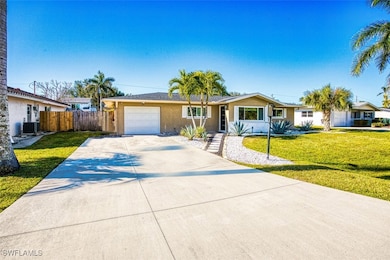 Ranch-style home with a garage, a front yard, and