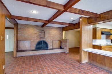 Classic wood-burning brick fireplace in the dining