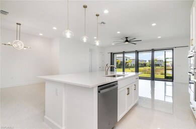 Kitchen featuring dishwasher, a sink, open floor p