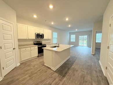 Kitchen with visible vents, dark wood finished flo