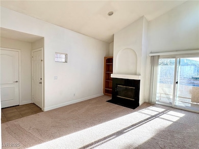 Unfurnished living room with carpet floors, high v