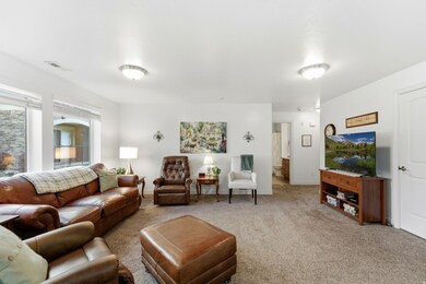 Carpeted living area with baseboards