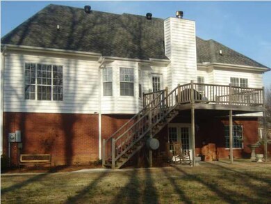Back view of home w/large deck and patio underneat