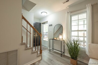 Entrance foyer featuring hardwood / wood-style flo