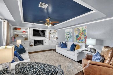Living room with a fireplace, built in features, c