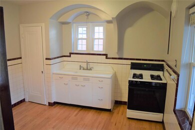 Gorgeous tile work and arches in retro kitchen