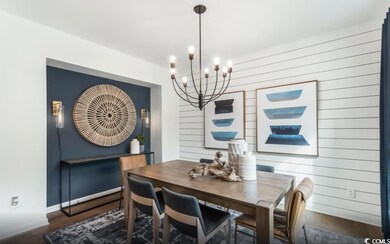 Dining area with a chandelier, wood finished floors, and wood walls
