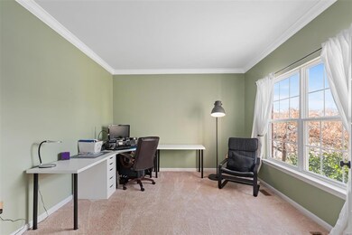 Main floor office with large windows and french do