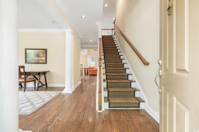 Stairs featuring ornamental molding, ornate column