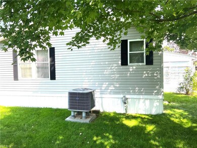 Back of home's exterior featuring  central air con