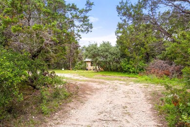 View of street with dirt driveway and a view of t