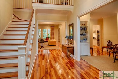 Enter into a two story open foyer with heart pine 