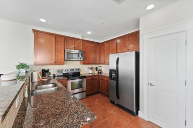 This well-appointed kitchen shines with granite countertops, custom tile backsplash, and warm wood cabinetry offering ample storage for all your culinary essentials.