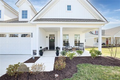 Entrance to property featuring covered porch and a