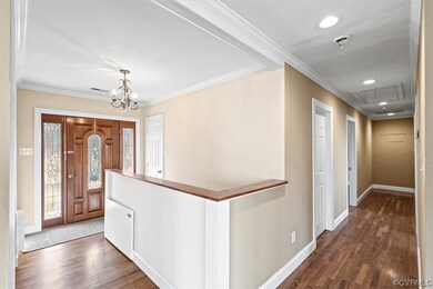 Entryway featuring an inviting chandelier, crown m