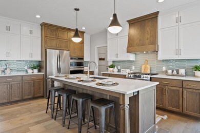 Immerse yourself in elegance as you step onto the rich and timeless maple hardwood floors that grace the main level, adding a touch of sophistication to every space.