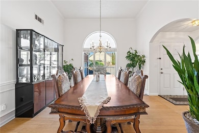 Dining area with a chandelier, light wood finished
