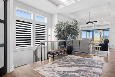 entryway with tray ceiling and indirect lighting