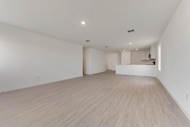 Unfurnished living room featuring light hardwood /