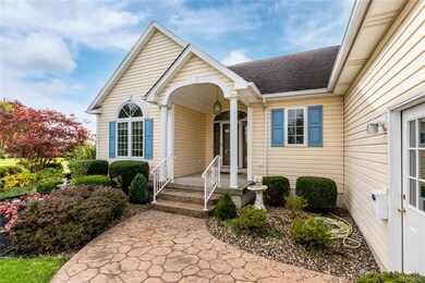 Stamped concrete walkway leads to covered porch