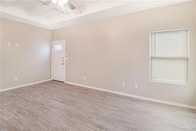 Unfurnished room with ceiling fan, light hardwood / wood-style floors, and a raised ceiling