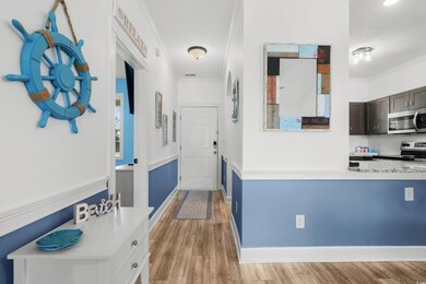 Hallway featuring crown molding, light wood finished floors, and baseboards